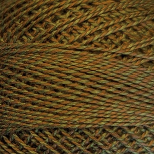 May include: A close-up of a ball of yarn with a brown and green variegated color.