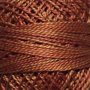 May include: A spool of embroidery floss in a deep orange and red color with a subtle shimmer.