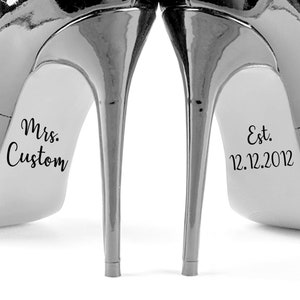 May include: A pair of black high-heeled shoes with the text "Mrs. Custom" on one shoe and "Est. 12.12.2012" on the other shoe.