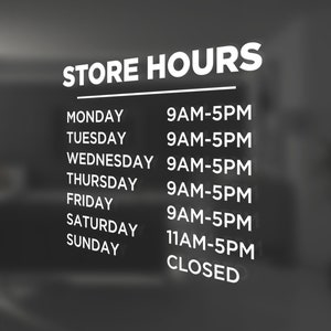 May include: Store hours sign with white text on a black background. The sign lists the hours of operation for each day of the week. Monday through Friday the store is open from 9 AM to 5 PM. Saturday the store is open from 11 AM to 5 PM. Sunday the store is closed.