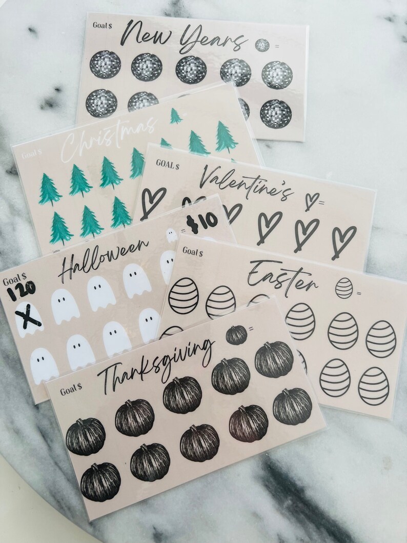 May include: A set of ten printable goal tracker sheets featuring various holiday themes. Each sheet includes a goal amount, a title, and a grid of icons to color in as goals are achieved. The themes include New Years, Christmas, Valentine's Day, Easter, Halloween, and Thanksgiving.