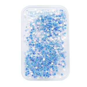 May include: A clear plastic case filled with iridescent blue star-shaped glitter.