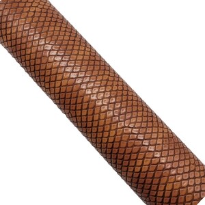 May include: A brown snakeskin-embossed leather sheet. The sheet has a textured surface that resembles snake scales.