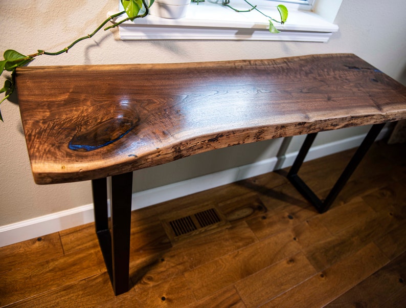A Beautiful black walnut live edge console table for behind the sofa or couch. This table is made by Ozarkswoodland.  It is made from premium American black walnut that was milled from the Amish here in the heart of the Ozarks.
