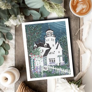 May include: A white and black illustration of a house with a tower, surrounded by greenery and a white picket fence. The artwork has a night sky background with stars. The word "Magic" is written on a small sign.