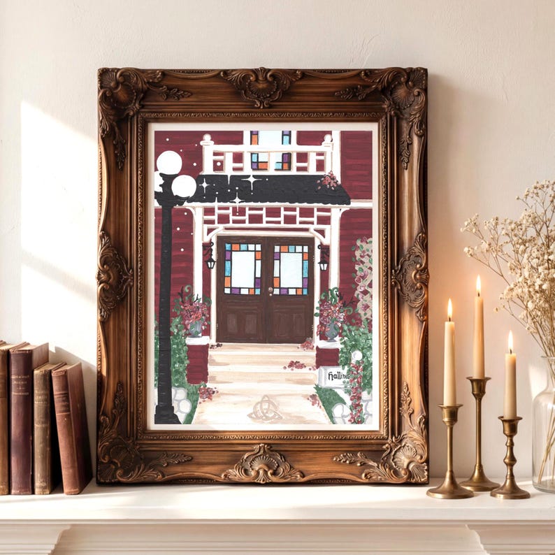 May include: A framed print of a red building with a black roof and a white porch. The print features a detailed illustration of a house with a front door, stained glass windows, and a street lamp. The frame is ornate and brown.