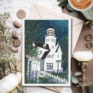 May include: A white illustration of a Victorian house with a tower, surrounded by a white picket fence and lush greenery. The night sky is dark blue with stars. The word "Magic" is visible on a small sign.
