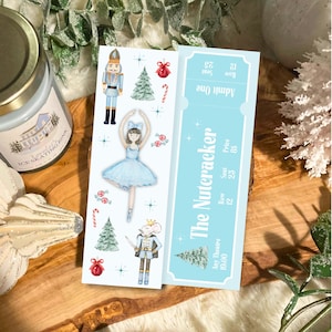 May include: A rectangular bookmark featuring a light blue ticket design for The Nutcracker with row 12 and seat 25. The adjacent section displays watercolor illustrations of a nutcracker, a ballerina in a blue tutu, a mouse king, pine trees, red ornaments, and candy canes.