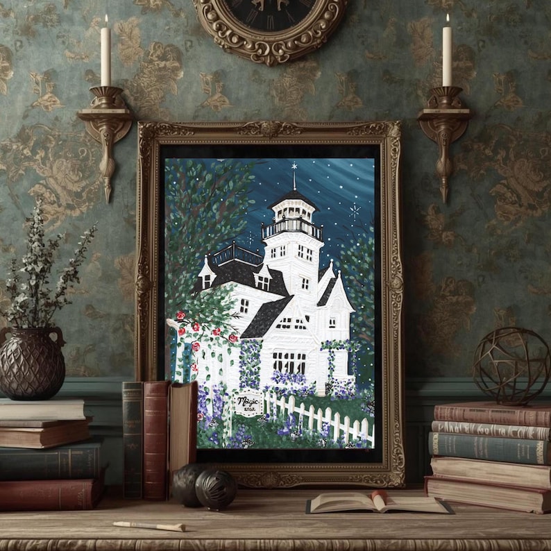 May include: A framed art print of a white lighthouse with a black roof and tower, set against a starry night sky. The artwork features a white picket fence, flowers, and the text "Magic Area". The frame is gold.