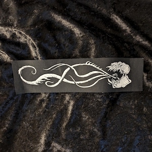 May include: A black and white graphic design of a creature with a long, winding body and a head that resembles a chest. The creature is depicted in a stylized, almost abstract manner, with its body resembling a series of interconnected curves and lines.