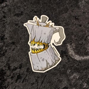 May include: A gray and white ceramic coffee pot with a monster face and yellow teeth. The pot has a handle and a spout. The text "GOODBYEZEACH" is printed on the side of the pot.