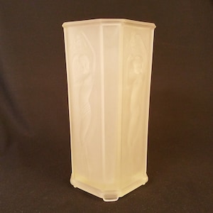 semi-nude woman adorns four sides of an eight-sided glass vase