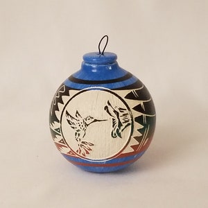 hummingbird on a carved Christmas tree ornament signed by artist