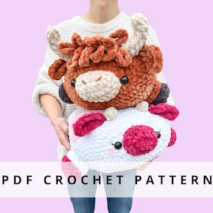 May include: Two plush crochet cow pillows, one brown and one white with pink accents, are held up. The brown cow has large horns and a fluffy texture. The white cow has pink ears and a pink nose. The text "PDF CROCHET PATTERN" is displayed.