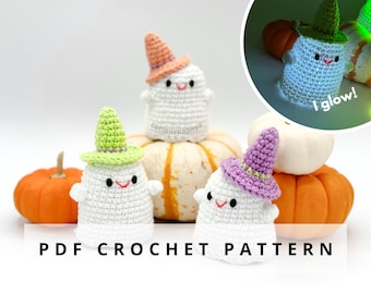 May include: Crocheted ghost figures with smiling faces and colorful witch hats. The ghosts are white with hats in orange, green, and purple. The image includes pumpkins and the text "PDF CROCHET PATTERN".