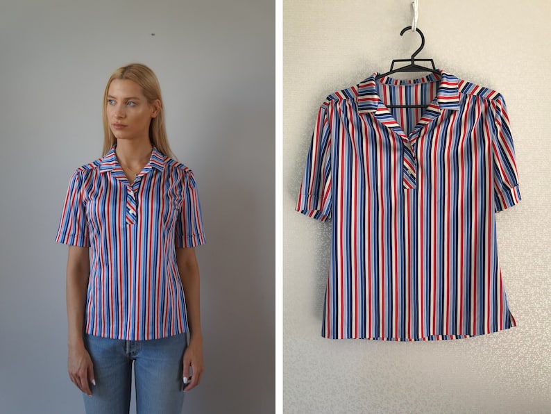 May include: A striped short-sleeved shirt with red, blue, and white stripes. The shirt has a collared neckline and a button closure.