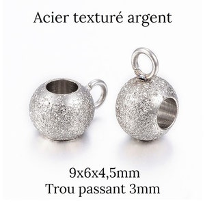 K&ouml;nnte beinhalten: Zwei silberne, strukturierte Metallperlen mit einem Loch zum Einf&auml;deln. Jede Perle misst 9 mm x 6 mm x 4,5 mm und hat ein 3 mm Loch.