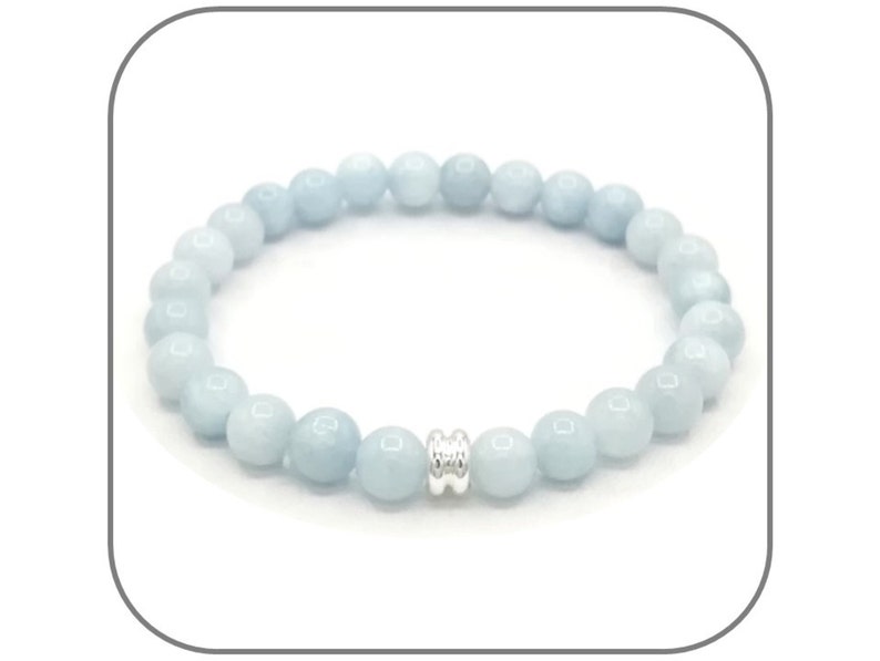 May include: A light blue gemstone bracelet with a silver bead accent. The bracelet is made of round beads and is approximately 7 inches in length.