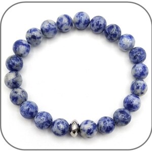 May include: A blue and white gemstone bracelet with a silver bead accent. The bracelet is made of round beads and is approximately 7 inches in length.