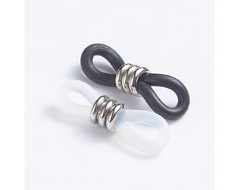 May include: Two pairs of eyeglass temple tips, one black and one clear, with a silver metal connector.