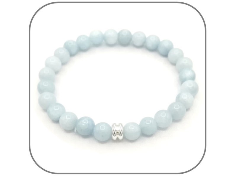 May include: A light blue gemstone bracelet with a silver spacer bead.