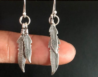 Metallic silver bullet necklace and painted feather earrings