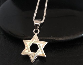 May include: A silver chain necklace with a white opal Star of David pendant.