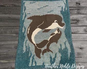 May include: A rectangular crochet blanket featuring a brown and cream dolphin mother and calf swimming together. The background consists of horizontal cream and teal stripes with teal seaweed accents. The text Heather Noble Designs is visible.
