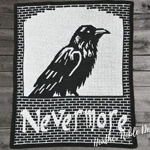 May include: Black and white crocheted blanket featuring a raven design. The raven is perched within a white rectangle, with the word "Nevermore" in white block letters below. The blanket has a brick-like border.