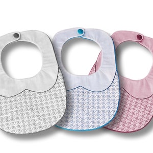 May include: Three baby bibs in white, blue, and pink. Each bib has a curved bottom edge with a wave pattern and a snap closure at the neck. The bibs are designed to catch spills and protect clothing.