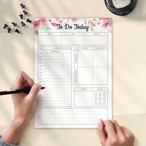 May include: A white to-do list with a floral design at the top. The list includes sections for schedule, urgent, not urgent, important, not important, fitness, and water. The list also includes a section for notes.