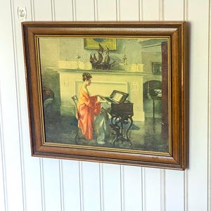 Vintage Framed &quot;At the Melodeon&quot; Lithography Print by Marguerite Stuber Pearson, Woman in Red Robe at Piano