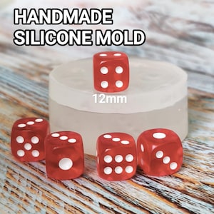 May include: A handmade silicone mold with five red dice, each with white dots. The dice are 12mm in size. The text "HANDMADE SILICONE MOLD" is at the top of the image.