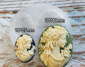 May include: Two silicone molds for making cameo-style jewelry. The molds are clear and show the design of the cameos. The larger mold is 30 x 40 mm and the smaller mold is 18 x 25 mm.
