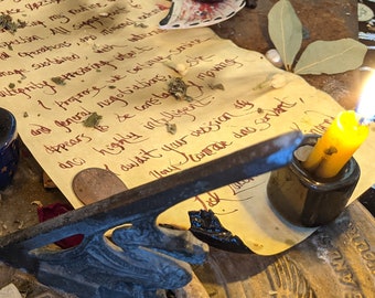 May include: A handwritten letter on parchment paper with a black bell, candles, and other objects on a wooden table. The letter reads: "My fellow traveler, you are free to prosper. However, I implore you to take the words I am expressing as my future advice to you. All I can offer is my own experience. All I can offer is my own experience, and what I will perpetually promise you is my unending support. I implore you to take what you are given. I trust you will be constantly aware and forever ready to be victorious. You are highly gifted, and I believe you are now subject to your own sense of art. What more can I want?"
