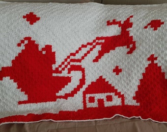Blanket crocheted. Handmade. Perfect gift. Christmas eve box. Traditions. Blanket depicting Santa, Sleigh & Reindeer flying over a house.