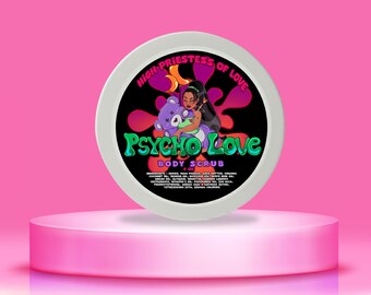 May include: A round, white container of "Psycho Love" body scrub, with a black label featuring a cartoon woman and a purple teddy bear. The label also includes the text "High Priestess of Love" and "Body Scrub". The container sits on a pink pedestal.