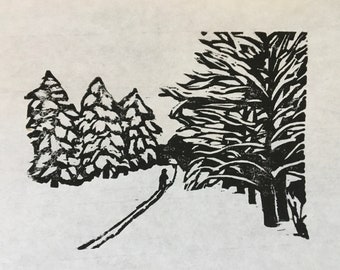 woodcut print of skier entering snowy woods by Vermont-based artist Margot Torrey