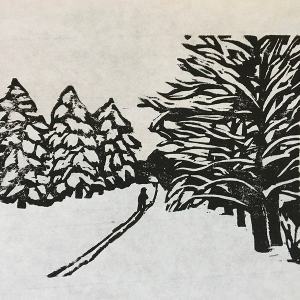 woodcut print of skier entering snowy woods by Vermont-based artist Margot Torrey