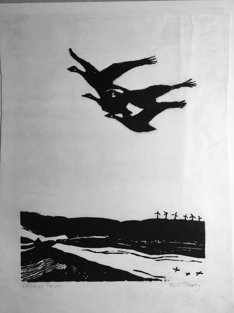 May include: Black and white linocut print of three geese flying in formation over a landscape with a river and trees. The print is titled "Heading South" and signed "M.G.Torrey".