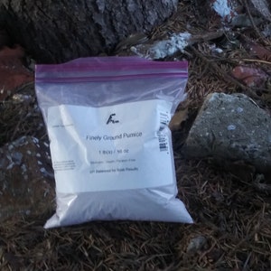 May include: A white plastic bag with a label that reads "Finely Ground Pumice 1 lb(s) / 16 oz pH Balanced for Best Results".