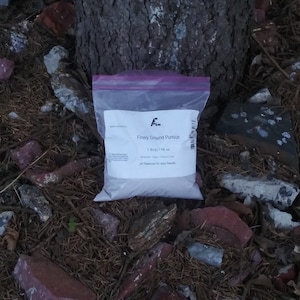 May include: A purple resealable bag containing finely ground pumice. The bag is labeled "Finely Ground Pumice 1 lb(s)/16 oz pH Balanced for Best Results".