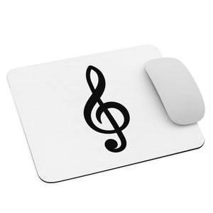 May include: A white mouse pad with a black treble clef symbol in the center.