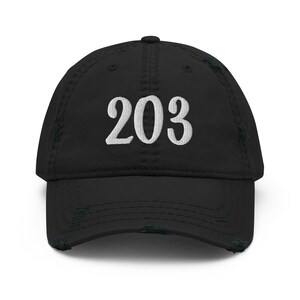 May include: Black distressed baseball cap with the number "203" embroidered in white script across the front. The cap has a curved brim and a worn, vintage look.