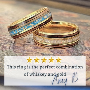 May include: Two rings featuring gold bands with dark wood inlays. One ring has a central inlay of turquoise and gold flakes, while the other features a white and gold flake inlay. Text reads: This ring is the perfect combination of whiskey and gold.