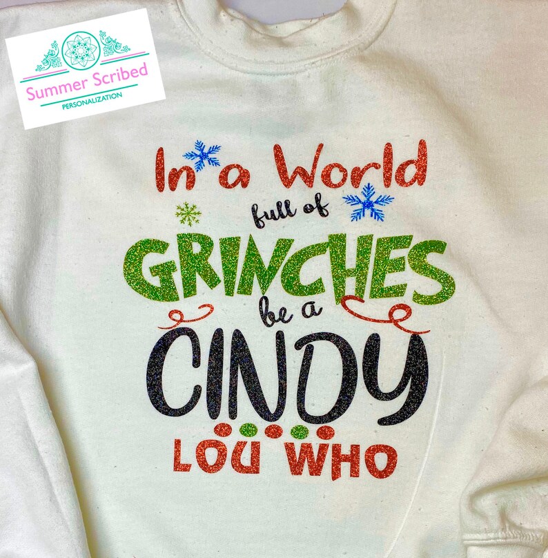 In a world full of Grinches Glitter HoodieSweatshirtTee