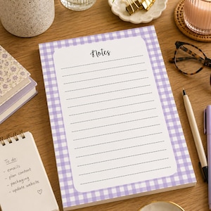 May include: A rectangular notepad featuring a light purple and white gingham pattern border. The centre white area contains the word Notes in black script at the top, followed by twelve horizontal dashed lines for writing tasks or reminders.