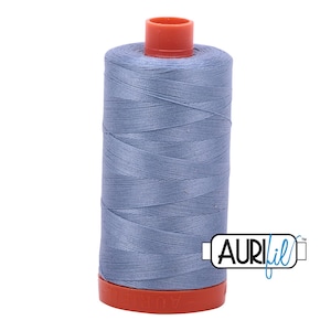 May include: A spool of light blue thread with a red plastic bobbin and the text "Aurifil" in blue.