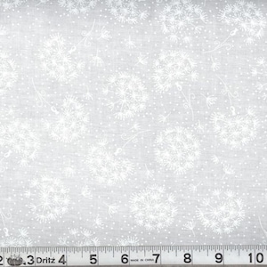 May include: White fabric with a repeating pattern of dandelion seed heads and small dots on a light gray background. A ruler is at the bottom of the image, showing measurements in inches.