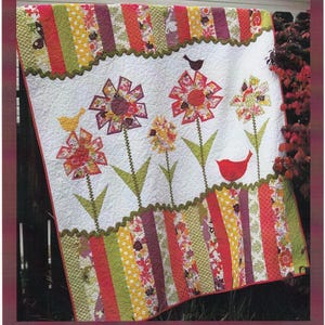 May include: A quilt pattern featuring a colorful floral design with red, yellow, and green flowers. The quilt is called "Dizzy Lizzy" and is from AbbeyLaneQuilts.com. The pattern number is #171.
